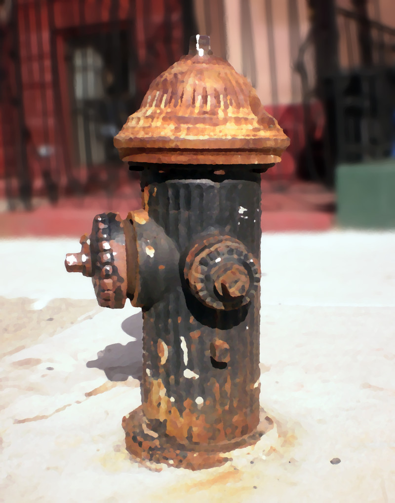 The Teamster: a stocky black hydrant with a dirty yellow bonnet is spotted with dirt, paint and concrete.